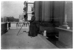 [Frances Benjamin Johnston with camera on balcony of Treasury Building, Washington, D.C., 1888]