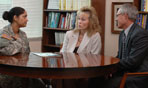 Photo of Chaplain conducting marriage counseling session over desk