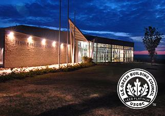 The Fernald Preserve Visitors Center at night with the Green Building Council LEED logo.