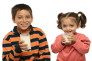 Children with milk mustaches while drinking a glass of milk