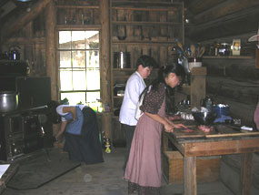 Young pioneers cooking in the Homestead Cabin.