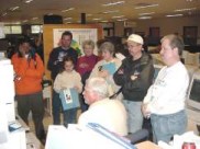 Visitors listen to a NOAA Weather Radio broadcast