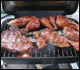 Variety of meat products on barbecue grill