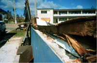 Unreinforced masonry wall building demolished by wind, note inadequate anchorage