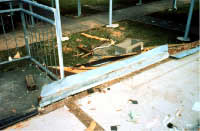 Concrete floor slab of school building blown apart by wind: note lack of base connectors
