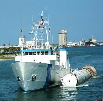 Freedom Star tows a booster at Port Canaveral.