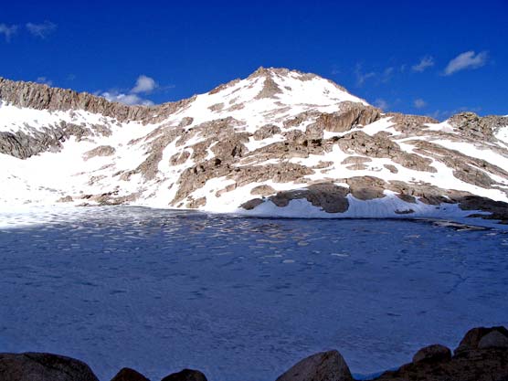 Frozen Columbine Lake with Sawtooth Mountain behind it