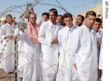 Iraqi detainees stand in line to be processed for release from Abu Ghraib prison Monday Sept. 26, 2005