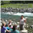 woman talking to group beside river