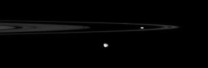 The Cassini spacecraft spies two of the small, irregular moons that patrol the outer edges of Saturn's main rings