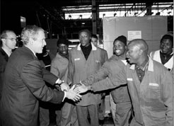 President Bush tours Ford Motor Companys automobile assembly plants roundtable on AIDS prevention with Ford employees in Pretoria, South Africa [White House photo office]