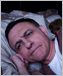 a photo of a frustrated man lying awake in bed