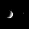 Titan, Saturn's largest moon and Mimas in the foreground are seen together 
in this view from Cassini. Titan's gravity is weaker than Earth's, so the 
moon's atmosphere is quite extended -- a quality hinted at in this view