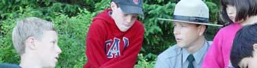 Ranger talks with children about park plants.