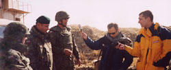 Journalists Lionel Thompson, holding microphone, and Pawel Szaniawski interview three soldiers on their dangerous duties. Photo courtesy U.S. Consulate General Munich, November 2003