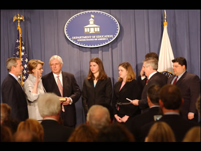 Margaret Spellings takes the oath of office, administered by White House Chief of Staff Andrew Card, as her family and President Bush look on.