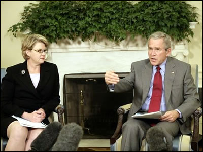 President Bush and Secretary Spellings meet with reporters in the Oval Office at the White House to discuss the Nation's Report Card.  White House photo by Eric Draper
