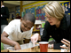 Secretary Spellings assists a student with a science experiment at Venetian Hills Elementary School, a 2007 No Child Left Behind - Blue Ribbon School in Atlanta, Georgia.