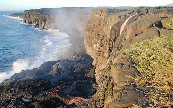 Lava pours over former sea cliff at Lae`apuki, Kilauea Volcano, Hawai`i