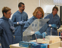 Participants at a training workshop on bloodborne diseases in Albuquerque, New Mexico (August 2005) practice their skills at blood smears.
