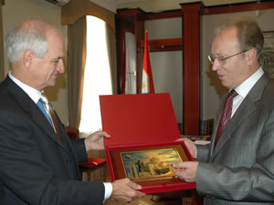 Valeriy Saratov (right), Head of the Sevastopol City Council, presents Dr. Douglas Menarchik, USAID Assistant Administrator for Europe and Eurasia, with a plaque featuring images of local landmarks.