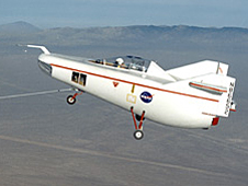 M2-F1 in flight over lakebed on tow line.