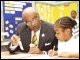 Secretary Paige helps a student with her fractions during his visit to West Oak Lane charter school in Philadelphia on May 21, 2003.