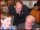 Dr. Hickok and Congressman Walden (R-OR) watch as a Washington Elementary School student uses a laptop computer at his classroom desk.