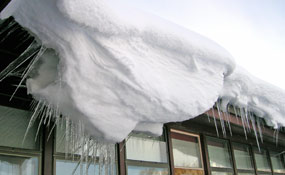 heavy snowload creeps over the roof of the administration building in Moose.