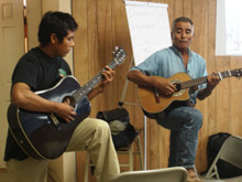 Father-and-son orange pickers Cesar Perez Tiburcio, left, and Cesar Perez Muños, wrote a song about the importance of wearing safety glasses.