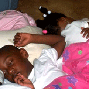 Two toddlers sleeping next to each other