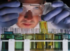 A scientist working with test tubes, exemplifying the many analyses that are conducted when determining the best regulatory options.