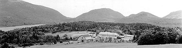 Civilian Conservation Corps camp with mountain backdrop