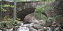 Cobblestone Bridge, faced with rounded cobblestones, has a stream running underneath.