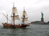 The Godspeed replica sails past the Statue of Liberty into New York Harbor