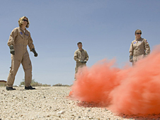 NASA Dryden videographers Lori Losey and Brian Soukup and flight test engineer Syri Koelfgen practice activating flares during land survival training.
