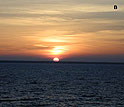 A picture of the setting sun off the coast of Estonia and the letter "B."