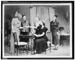 Women gathered around table in scene from The Women, a play by Clare Boothe Luce