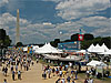 A crowd of people on the National Mall with the Washington Monument in the background
