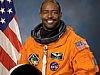 Leland Melvin in his orange spacesuit