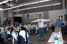 The Israeli students laugh as one of them participates in a physics experiment.