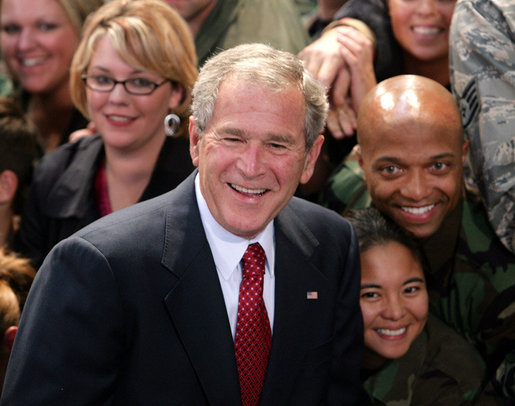 President George W. Bush poses for photos with members of the audience Monday, Aug. 4, 2008, after he delivered remarks to military personnel at Eielson Air Force Base in Alaska. White House photo by Chris Greenberg