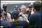 President George W. Bush poses for photos with members of the U.S. Olympic men's baseball team prior to a practice game against the Chinese Olympic men's baseball team Monday, Aug. 11, 2008, at the 2008 Summer Olympic Games in Beijing. White House photo by Chris Greenberg