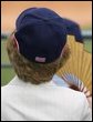 Mrs. Laura Bush wearing a U.S. Olympic baseball team hat watches the U.S. Olympic men's baseball team play a practice game against the Chinese Olympic men's baseball team Monday, Aug. 11, 2008, at the 2008 Summer Olympic Games in Beijing. White House photo by Shealah Craighead