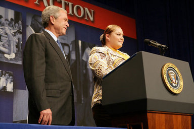 President George W. Bush listens as Edith Espinoza, Administrative Assistant, Chicano Federation, introduces him at the Office of Faith-Based and Community Initiatives National Conference Thursday, June 26, 2008, in Washington, D.C. The President opens his remarks, 'How beautiful was that? From being a homeless mother of two to introducing the President of the United States. There has to be a higher power. I love being with members of the armies of compassion, foot soldiers in helping make America a more hopeful place. Every day you mend broken hearts with love. You mend broken lives with hope. And you mend broken communities with countless acts of extraordinary kindness.' White House photo by Chris Greenberg.