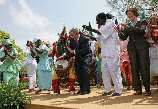 President George W. Bush and Mrs. Laura Bush take the stage with the Kankouran West African Dance Company after delivering remarks during a ceremony marking Malaria Awareness Day Wednesday, April 25, 2007, in the Rose Garden. White House photo by Eric Draper