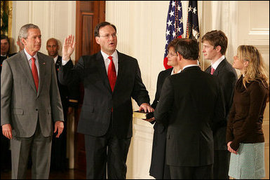 President George W. Bush looks on during the swearing-in ceremony for U.S. Supreme Court Justice Samuel A. Alito, Tuesday, Feb. 1, 2006 in the East Room of the White House, sworn-in by U.S. Supreme Court Chief Justice John Roberts. Alito's wife, Martha-Ann, their son Phil and daughter, Laura, are seen to the right. White House photo by Shealah Craighead