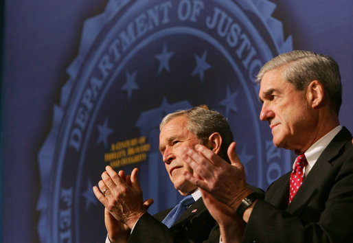 President George W. Bush and FBI Director Robert Mueller applaud the class speaker Thursday, Oct. 30, 2008, at the graduation ceremomy for FBI special agents in Quantico, Va. President Bush addressed the graduates and thanked them for stepping forward to serve their country. White House photo by Joyce N. Boghosian