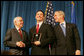 President George W. Bush and U.S. Attorney General Michael Mukasey congratulate FBI special agent graduate Richard Brooks, center, after he is presented with the Director's Leadership Award Thursday, Oct. 30, 2008, during the graduation ceremomy for FBI special agents in Quantico, Va. White House photo by Joyce N. Boghosian