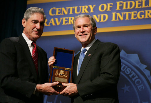 President George W. Bush is presented with an honorary FBI Special Agent credential by FBI Director Robert Mueller Thursday, Oct. 30, 2008, at the graduation ceremomy for FBI special agents in Quantico, Va. White House photo by Joyce N. Boghosian